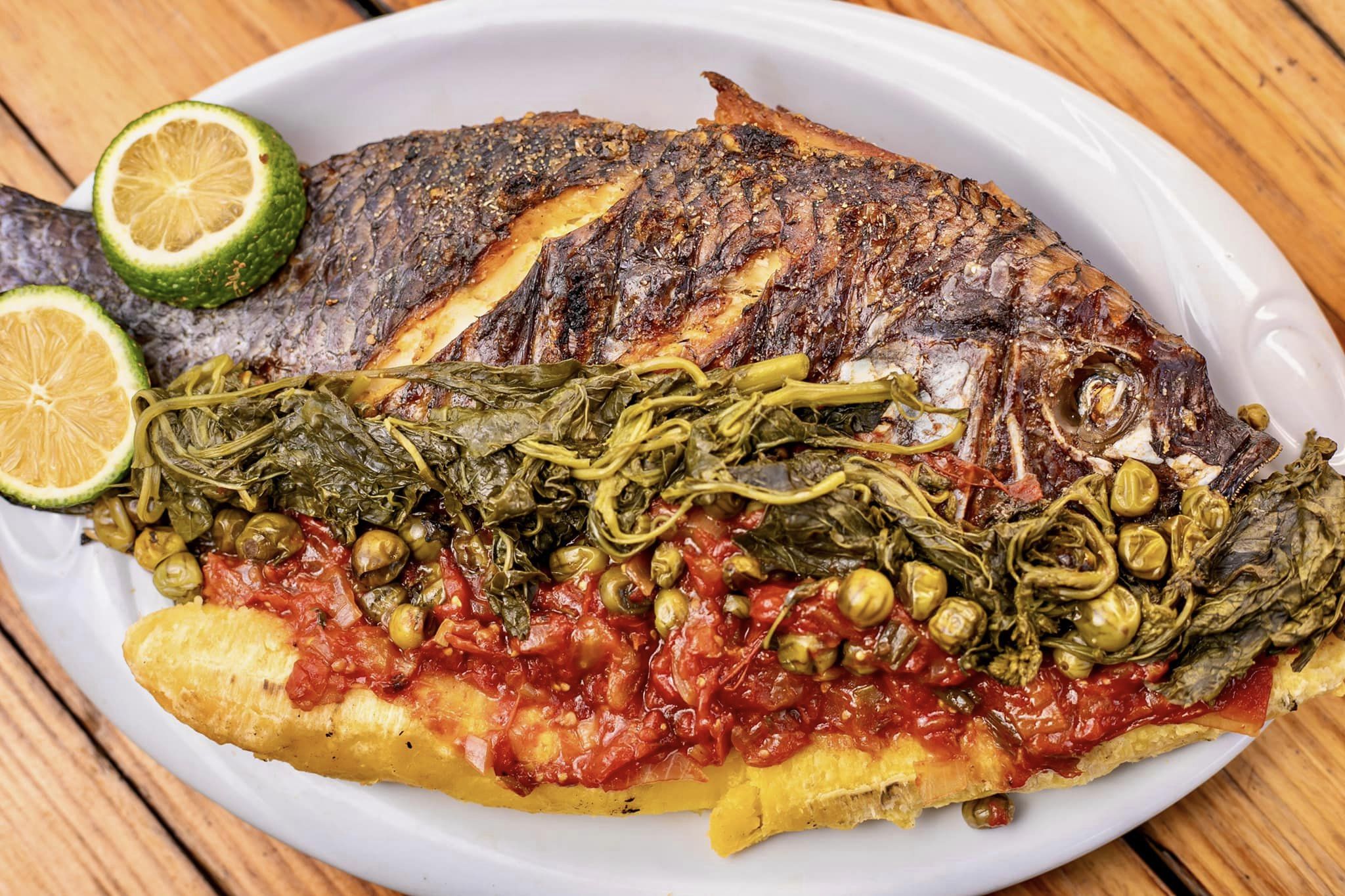 Grilled Whole Tilapia with a side of veges and plantain Ugandan Cuisine